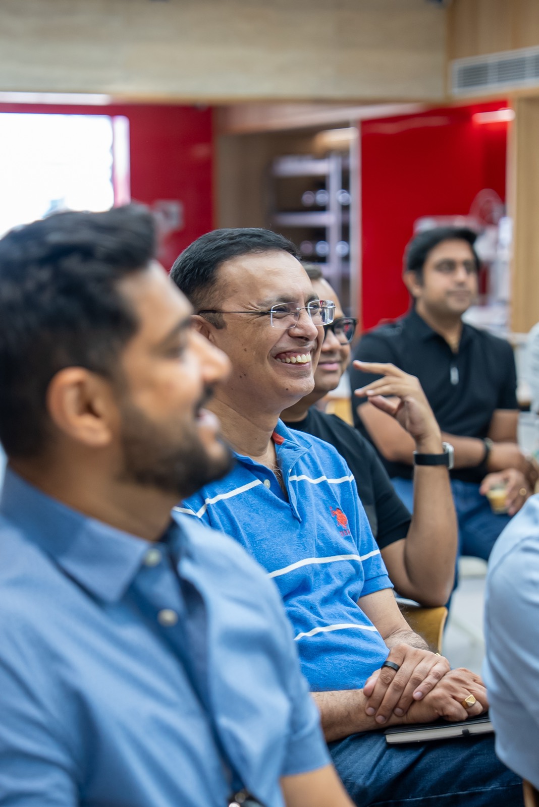 Two attendees comparing card apps on their phones at Miles Ahead Delhi