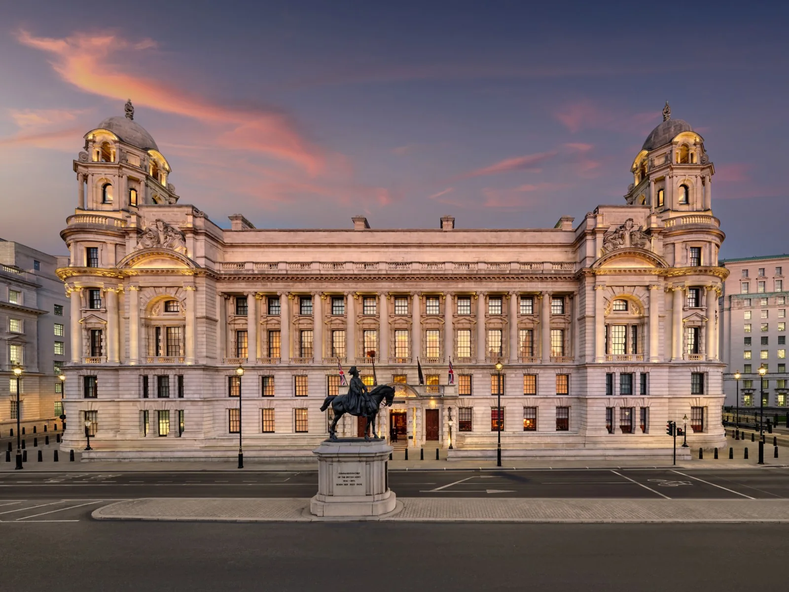 The Edwardian facade of Raffles London at The OWO on Whitehall at dusk