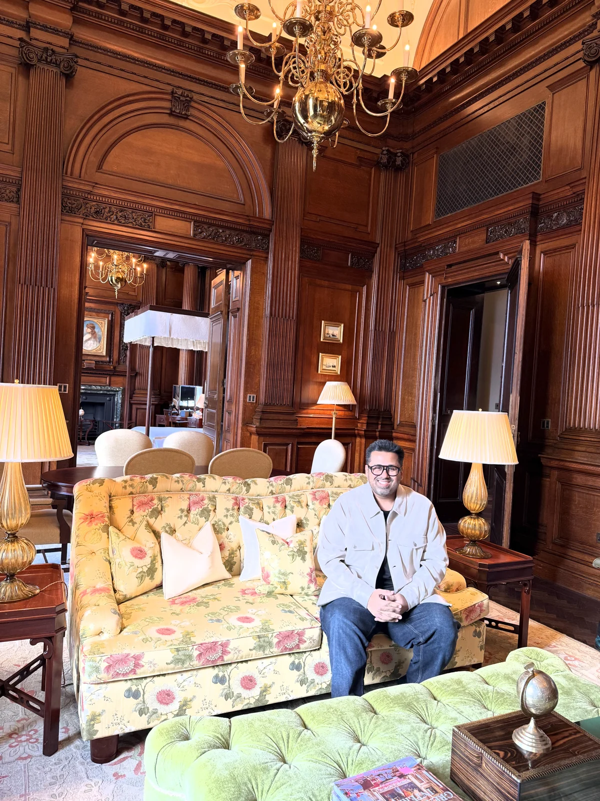 Oak-panelled sitting room of the Granville Suite with chandelier and floral sofa