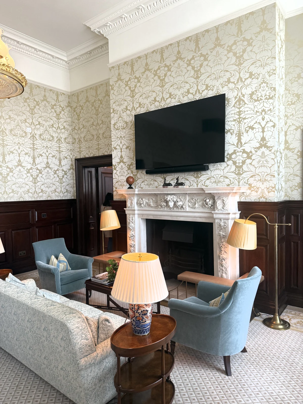 Damask-walled sitting room with fireplace in the Haldane Suite