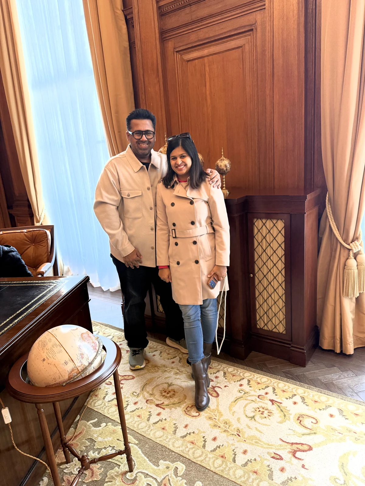 Aadil and Saniya by the globe in the Haldane Suite