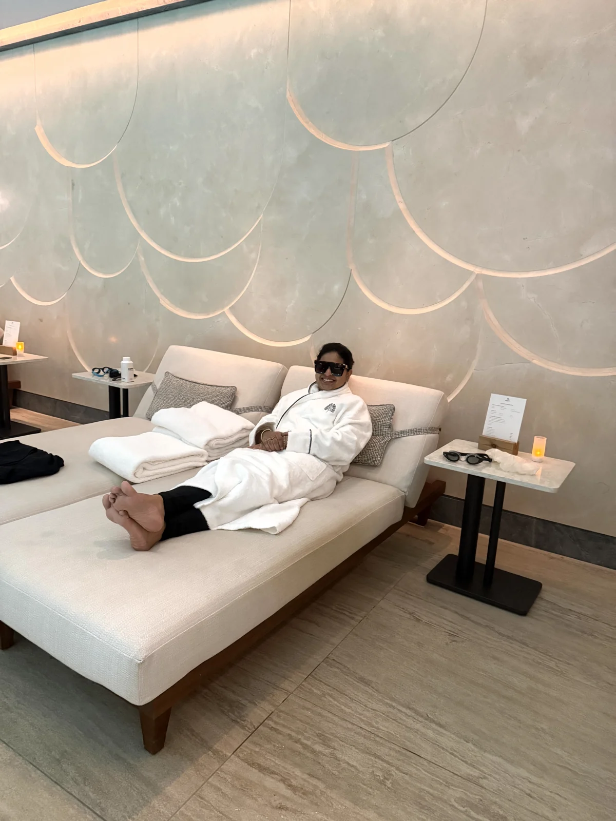 Aadil in a robe by the pool at the Guerlain Spa